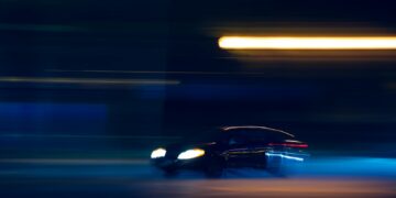 black car on road during night time