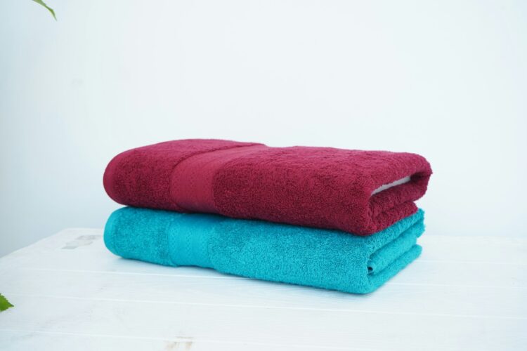 A stack of three towels sitting on top of a table