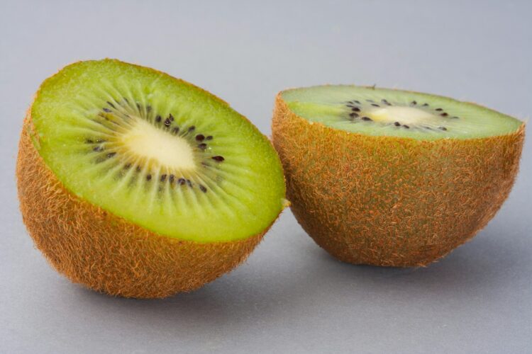Sliced green fruit on white surface