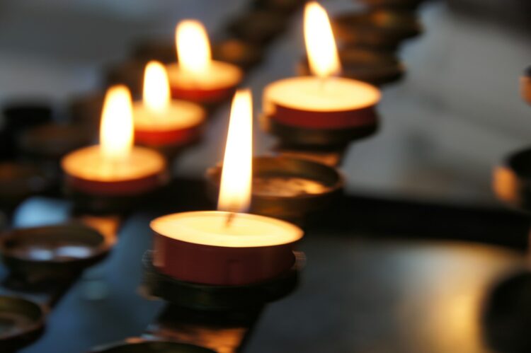 Lighted candles on black metal candle holder