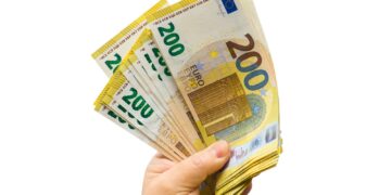 a person holding a bunch of money in their hand