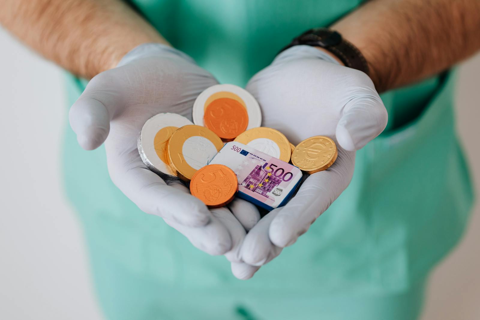 A healthcare worker with gloves holding euro coins and a bill symbolizing medical finance