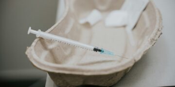 white and green ballpoint pen on brown wooden round table