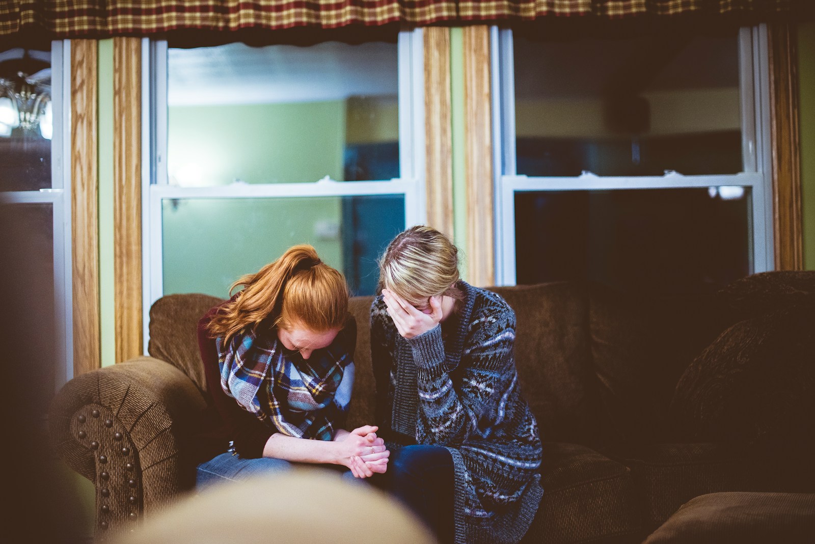 Man and woman sitting on sofa in a room