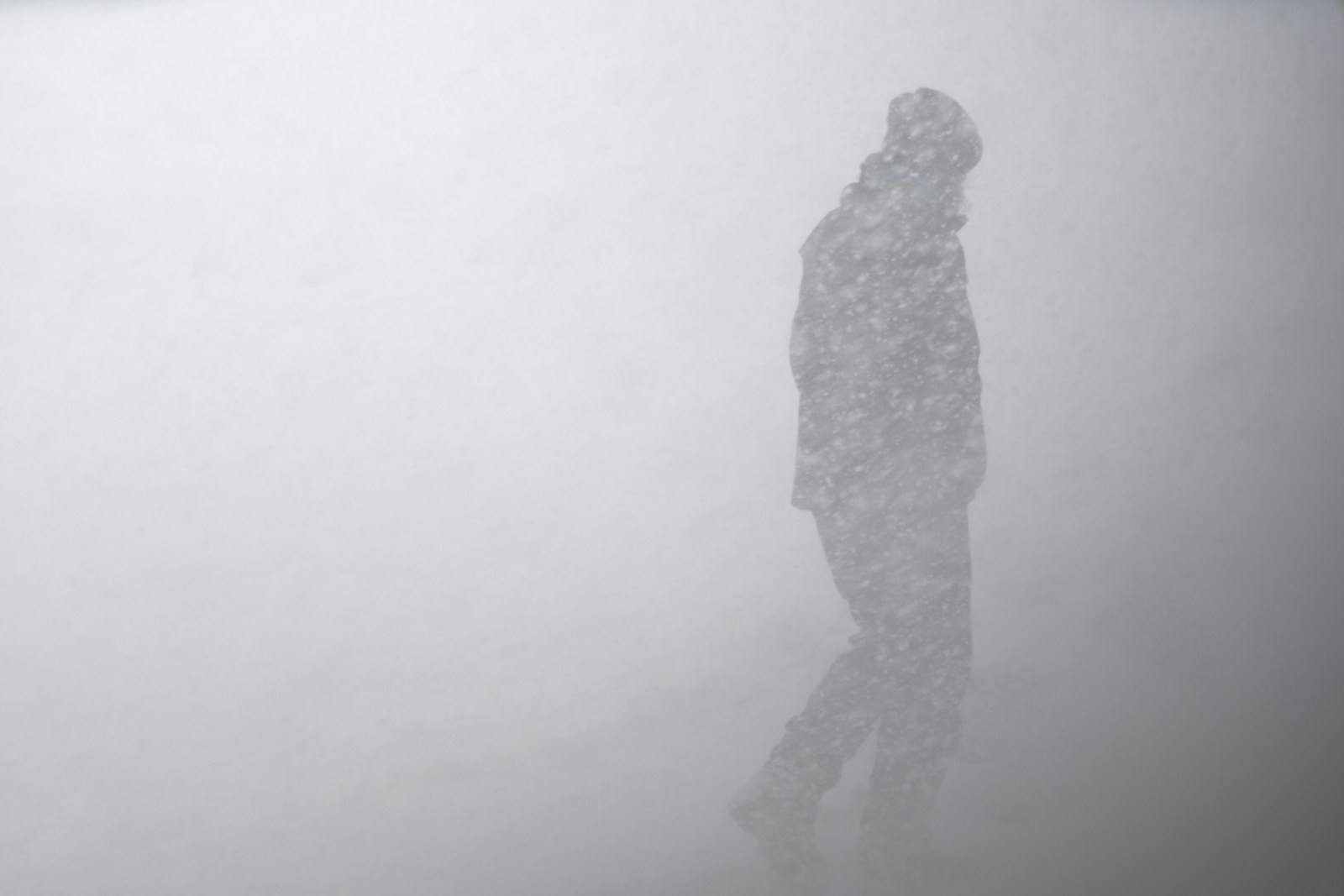 Silhouette of man in snow storm