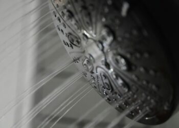 A close up of a shower head in a bathroom