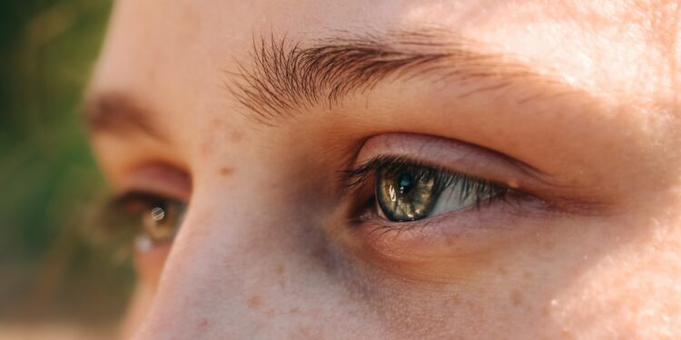 A close up of a person's eye with a blurry background
