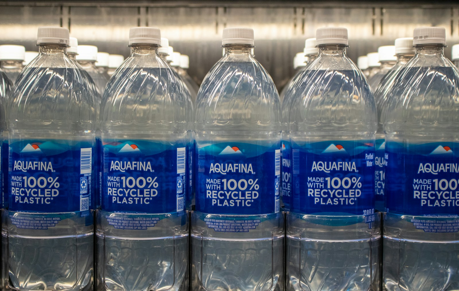 Bottles of aquafina water made with recycled plastic