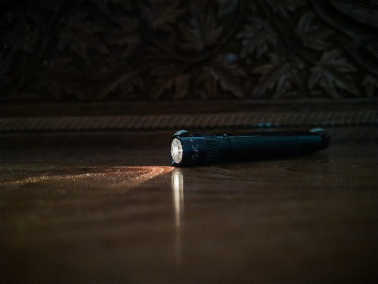 A flashlight sitting on the floor of a room