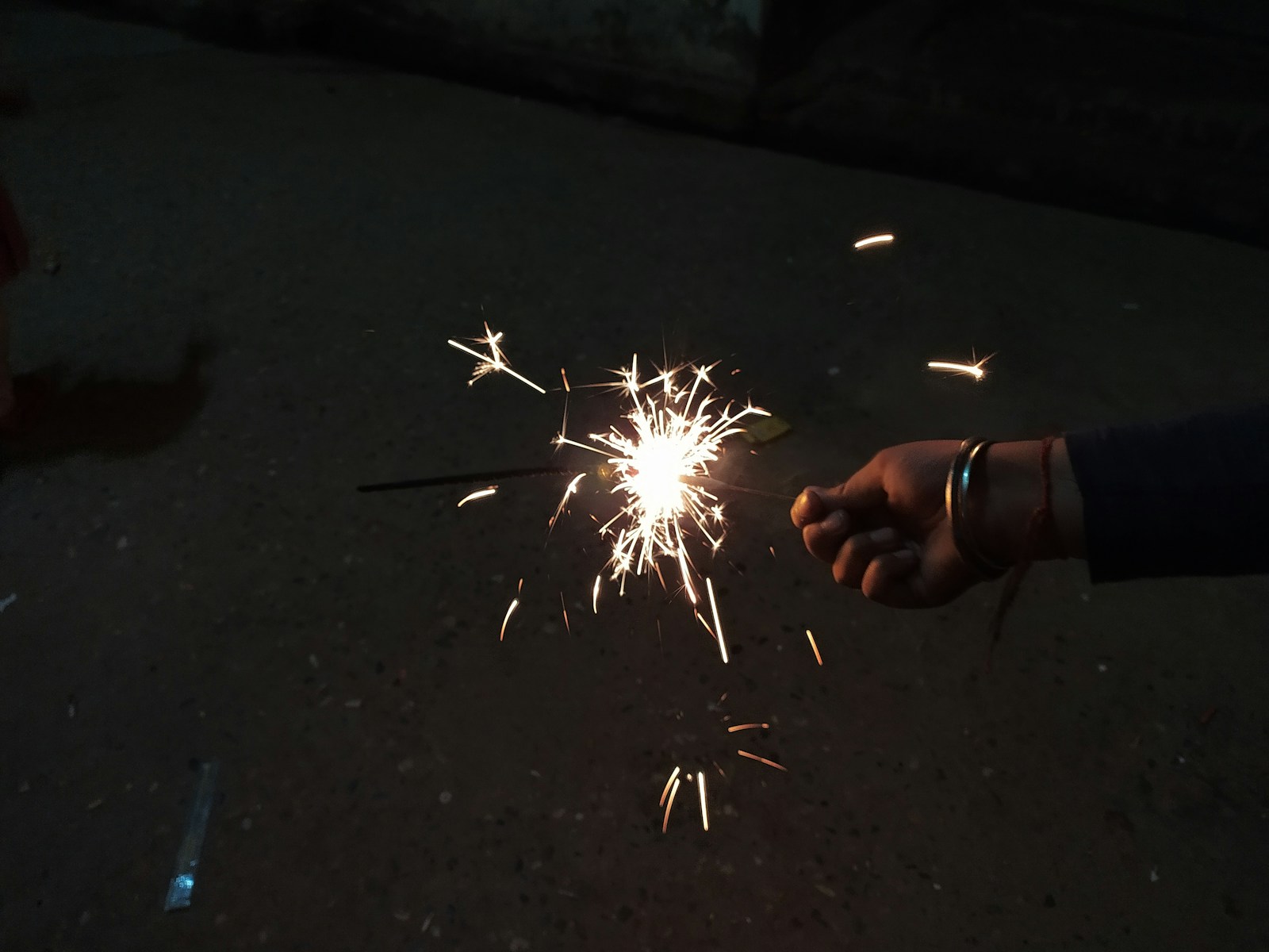 A person holding a sparkler in their hand