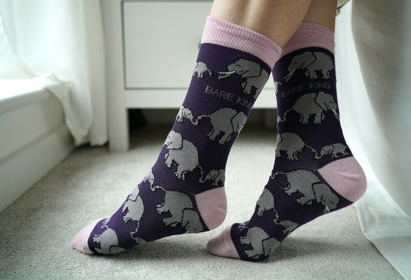 A person wearing socks with elephants on them