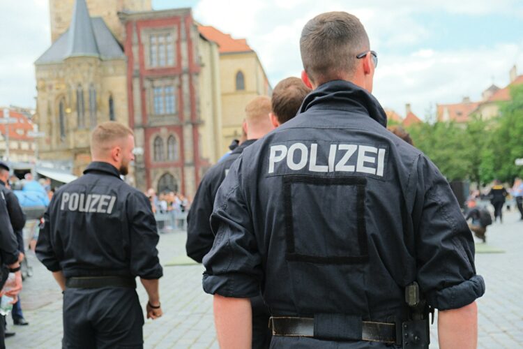 German police officers are standing in a public area