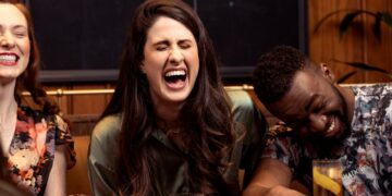 a group of people sitting around a table with drinks