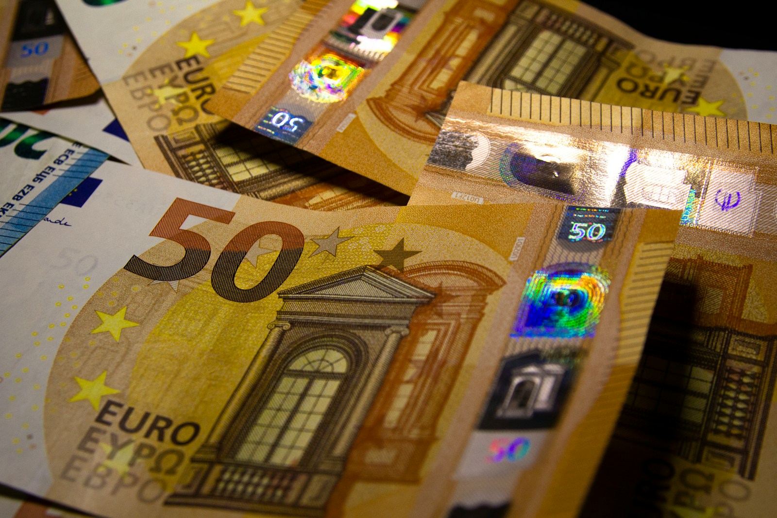 A pile of 50 euro bills sitting on top of each other