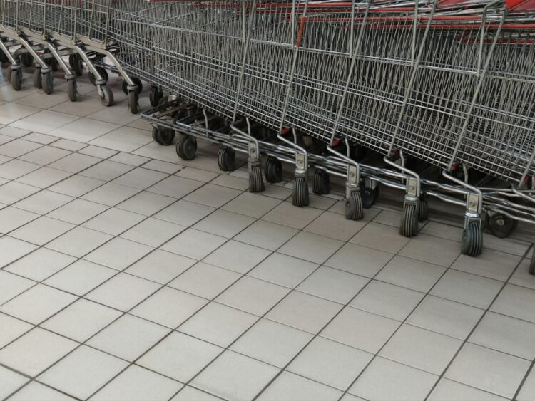 A row of empty shopping carts in a store