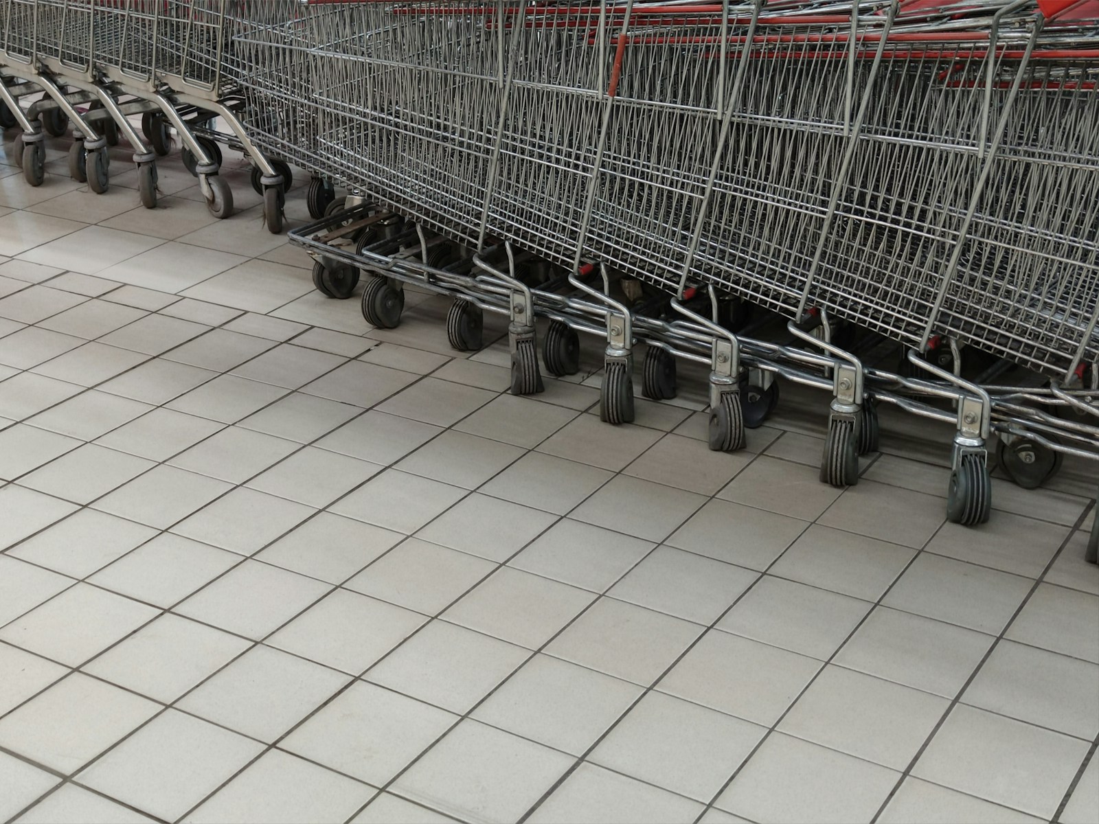 A row of empty shopping carts in a store