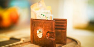 A wallet with money sticking out of it