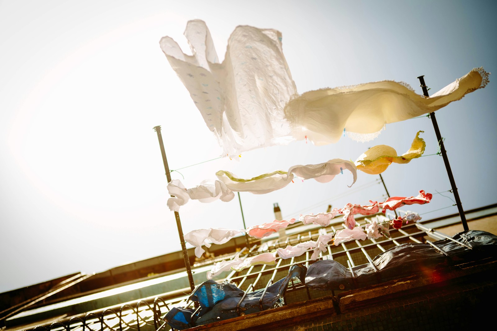 Low angle photography of hanging clothes outside house during daytime