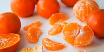 sliced orange fruits on white ceramic plate