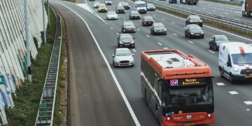 Traffic on a multi-lane highway with a bus.