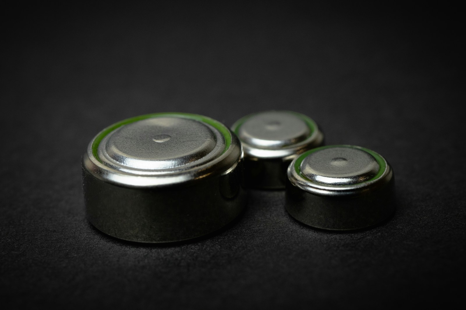 A group of three batteries sitting on top of a table