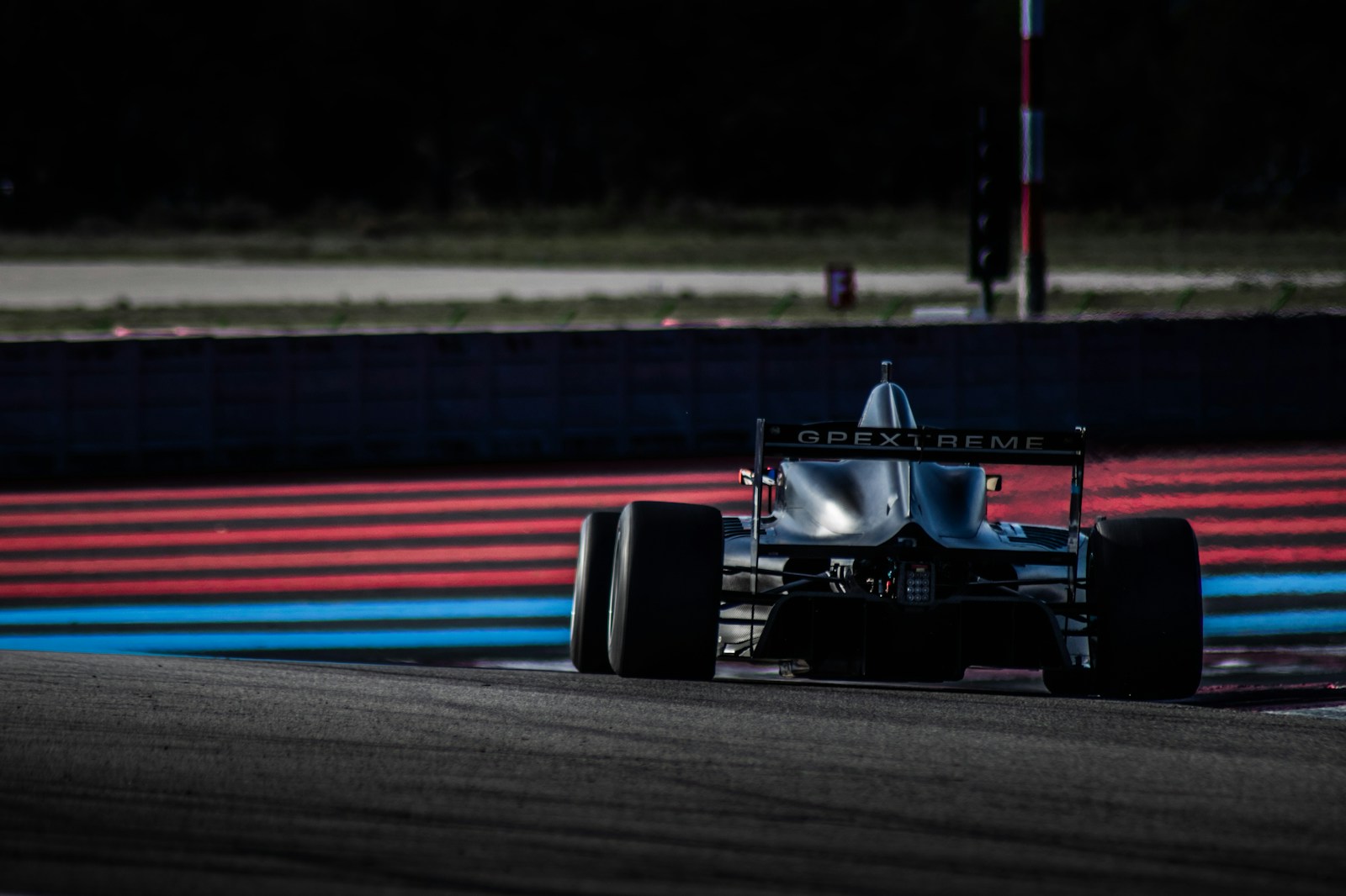 Photo by Clément Delacre - Info Vandaag Red and black f 1 race car on track during daytime