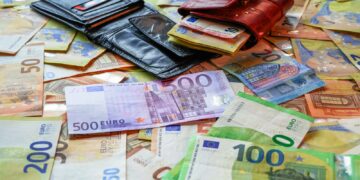 a pile of money sitting on top of a table