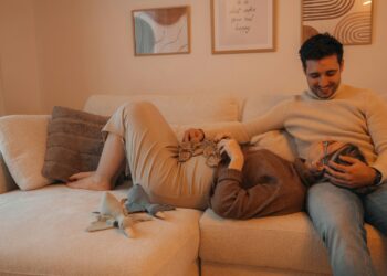 A man and a woman laying on a couch