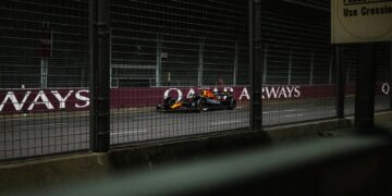 A race car is driving on the track.