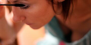 A woman with a pencil in her mouth