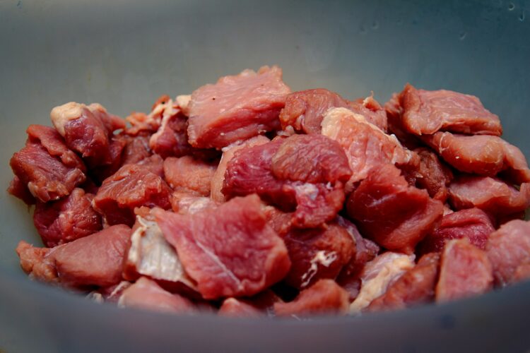 Raw meat on blue ceramic bowl