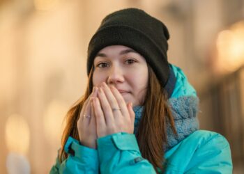 Woman in blue jacket wearing black knit cap