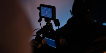 black flat screen tv turned on near white wall