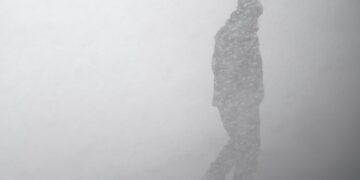 silhouette of man in snow storm