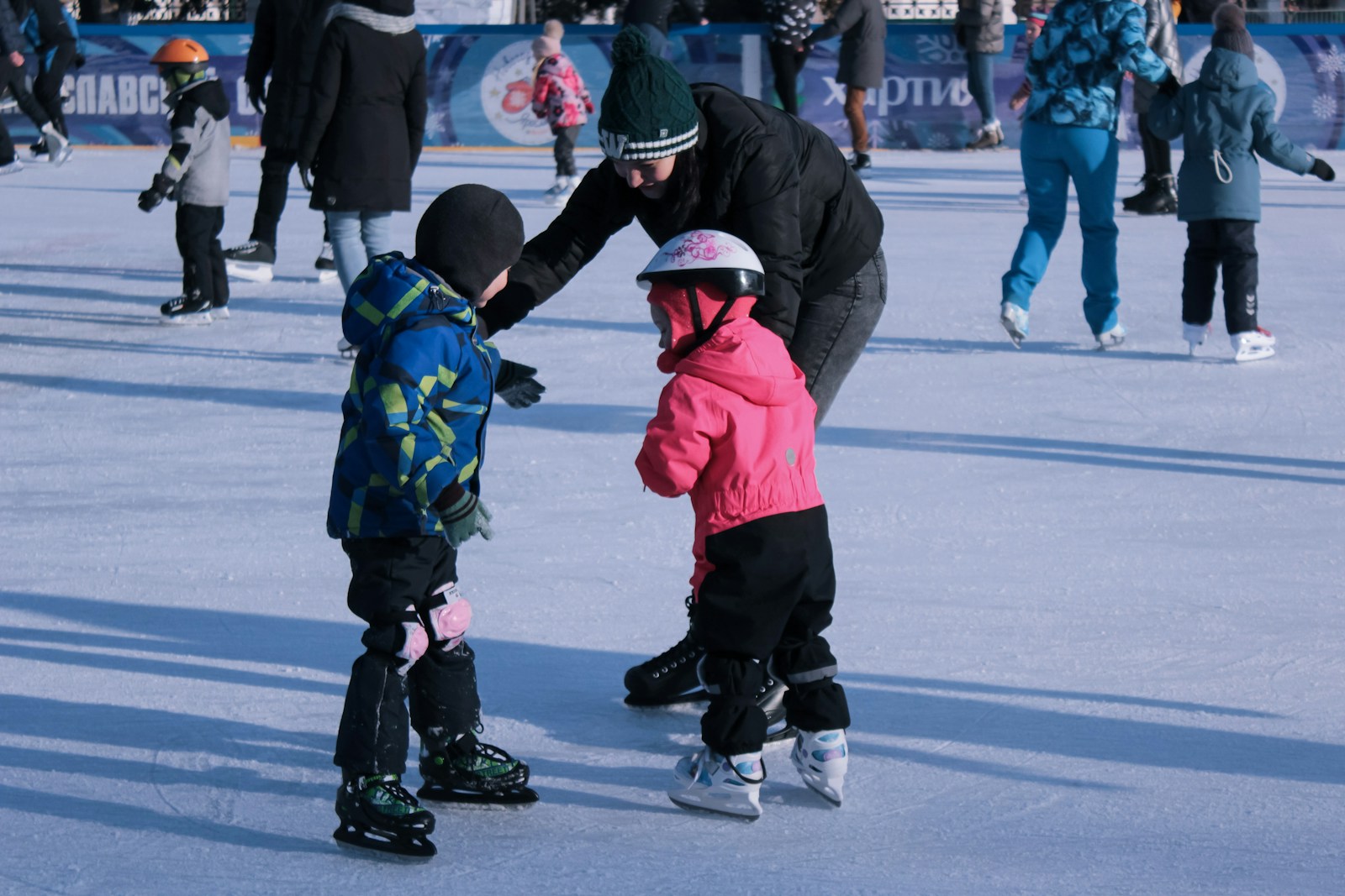 Photo by Maxim Shklyaev - Info Vandaag 2 children in red jacket and black pants playing ice hockey