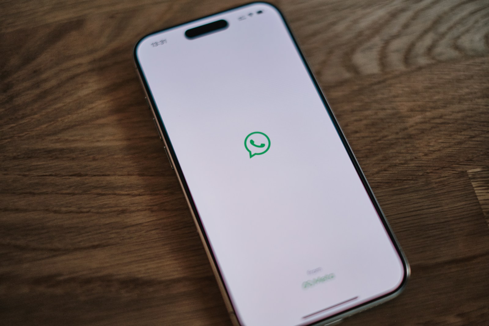 A white phone with a green message bubble on it