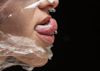 Person with white plastic pack on mouth