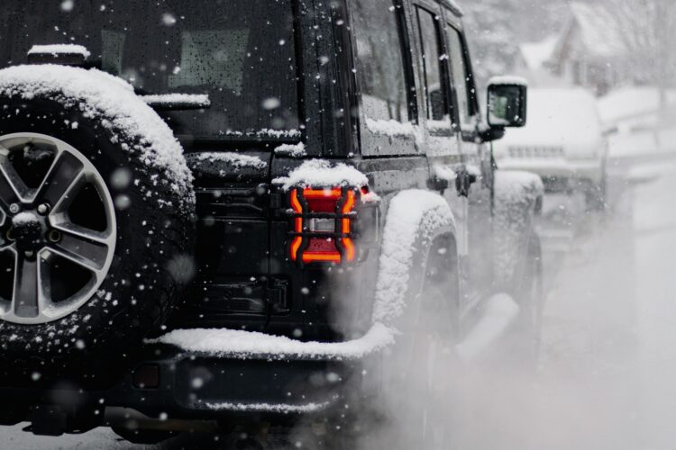 A jeep driving down a snow covered road