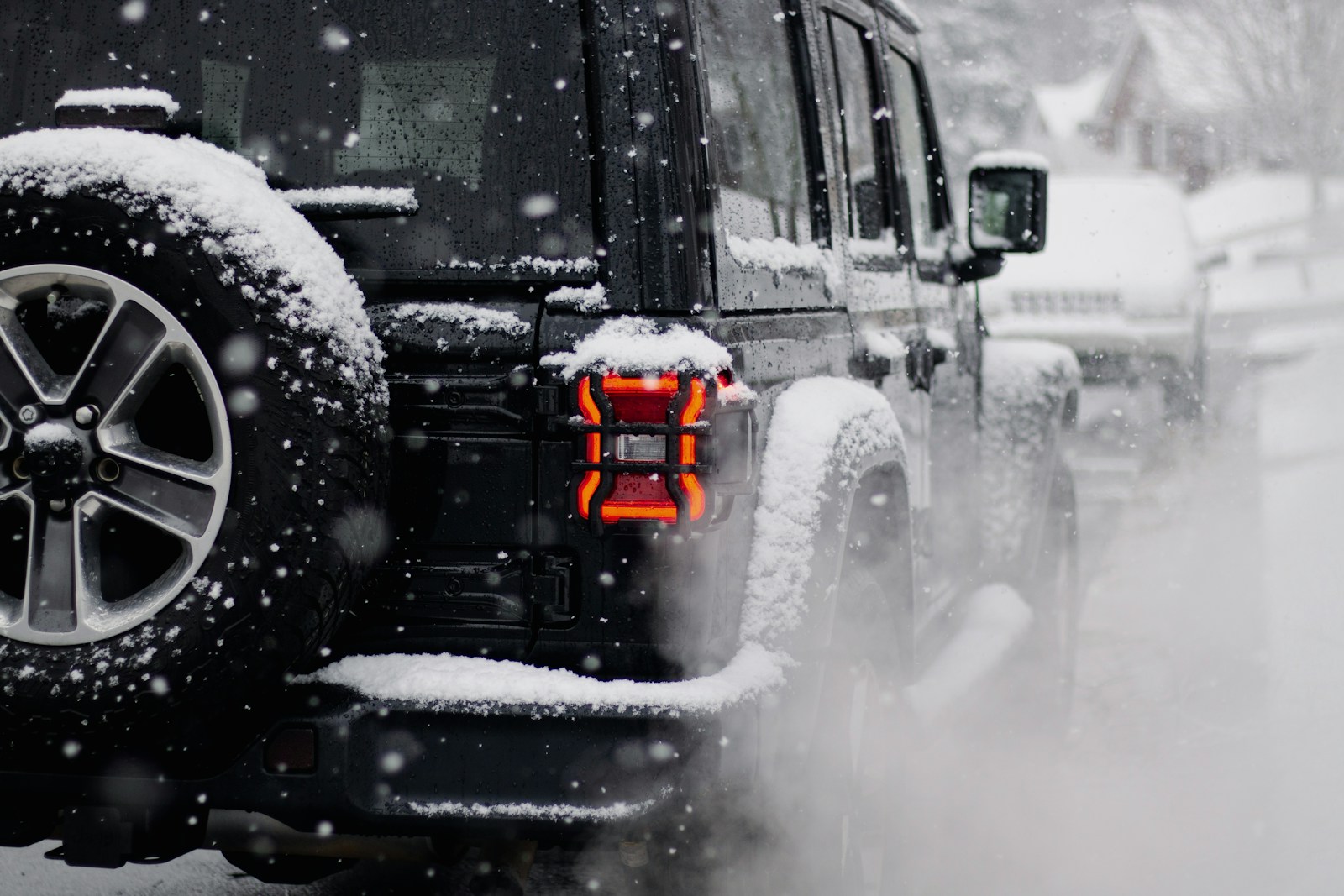 A jeep driving down a snow covered road