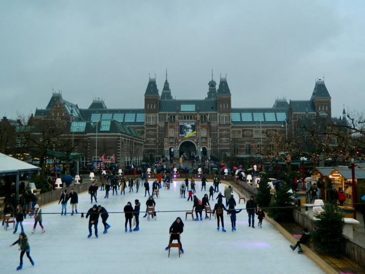 A group of people skating on an ice rink