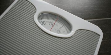 a bathroom scale sitting on top of a wooden table