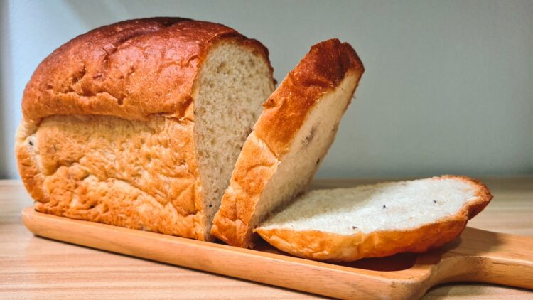 A loaf of bread with a slice cut out