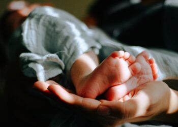 Person holding baby feet