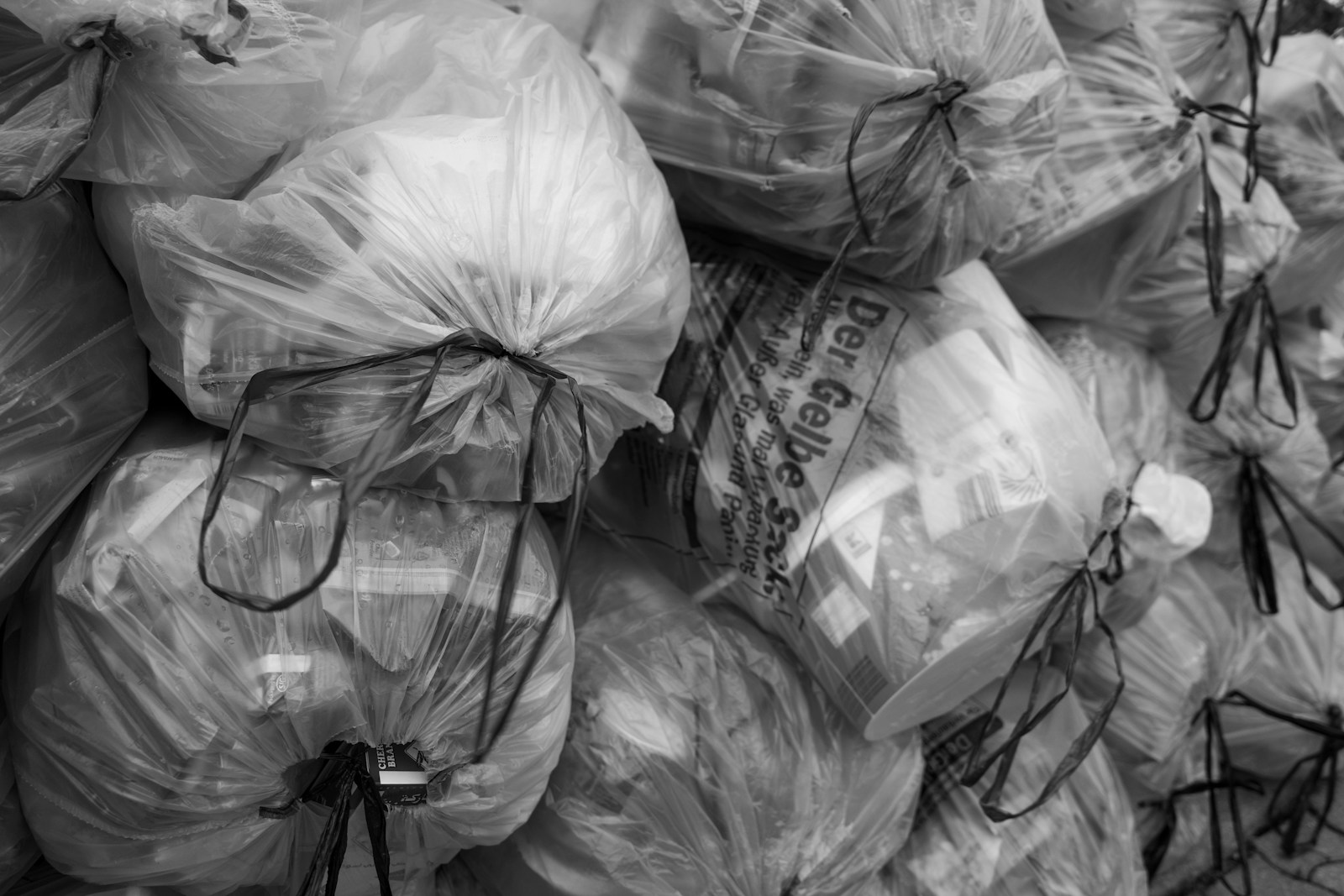 A pile of clear plastic trash bags filled with items