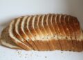 A sliced loaf of bread sitting on top of a white counter