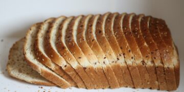 A sliced loaf of bread sitting on top of a white counter