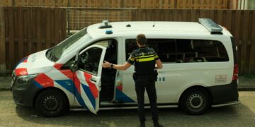 a police officer standing next to a van