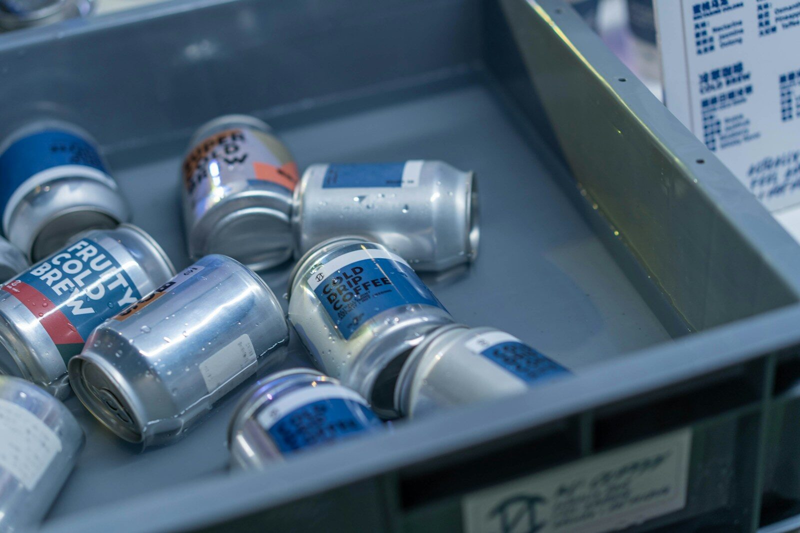 A metal bin filled with cans of soda