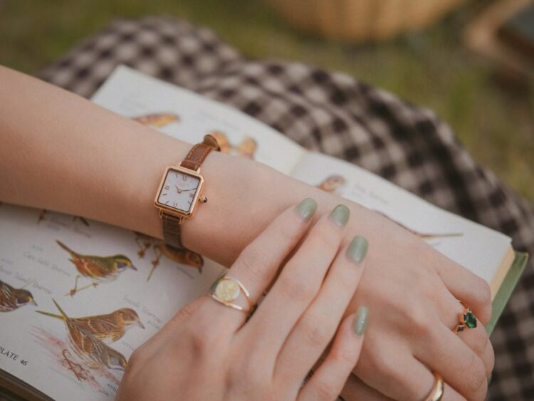 A person's hands with a watch on their wrist