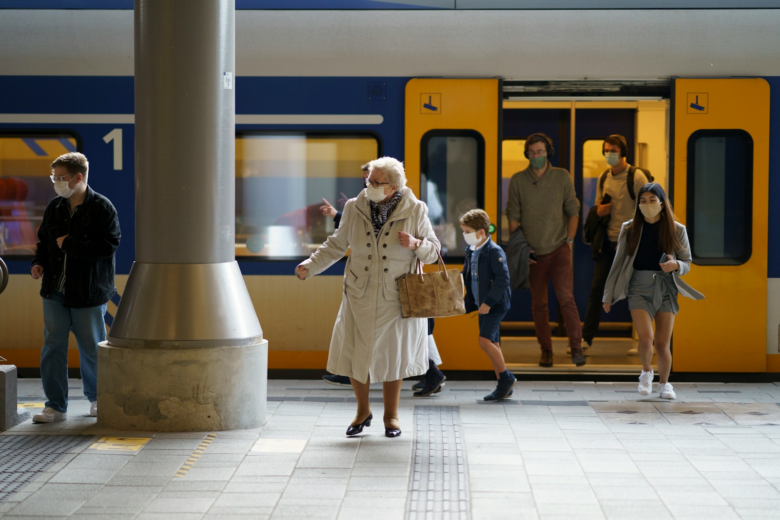 Woman in white coat standing on white floor tiles